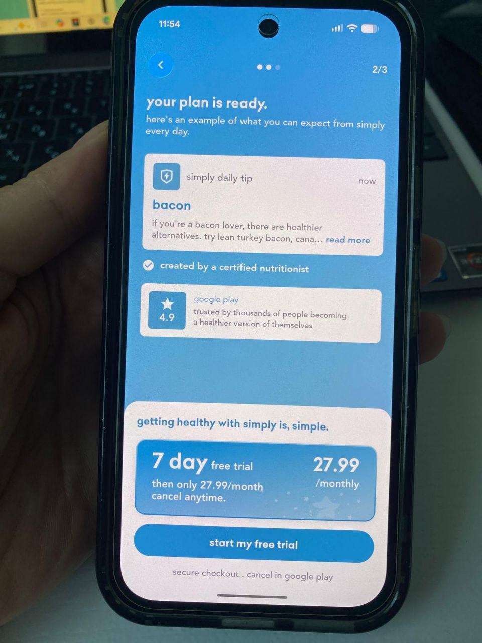 Screenshot of Simply’s “your plan is ready” onboarding screen: a generic “simply daily tip” about bacon substitutes is shown as the example of what the plan delivers, followed directly by a “7 day free trial, $27.99/monthly, cancel anytime” pricing card and a “start my free trial” button — no personalized plan has been generated from the user’s own goals yet.
